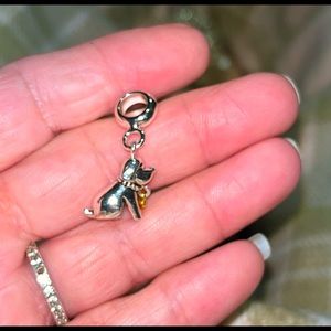 Cute little dog charm in silver tone and a gold tone heart that moves.